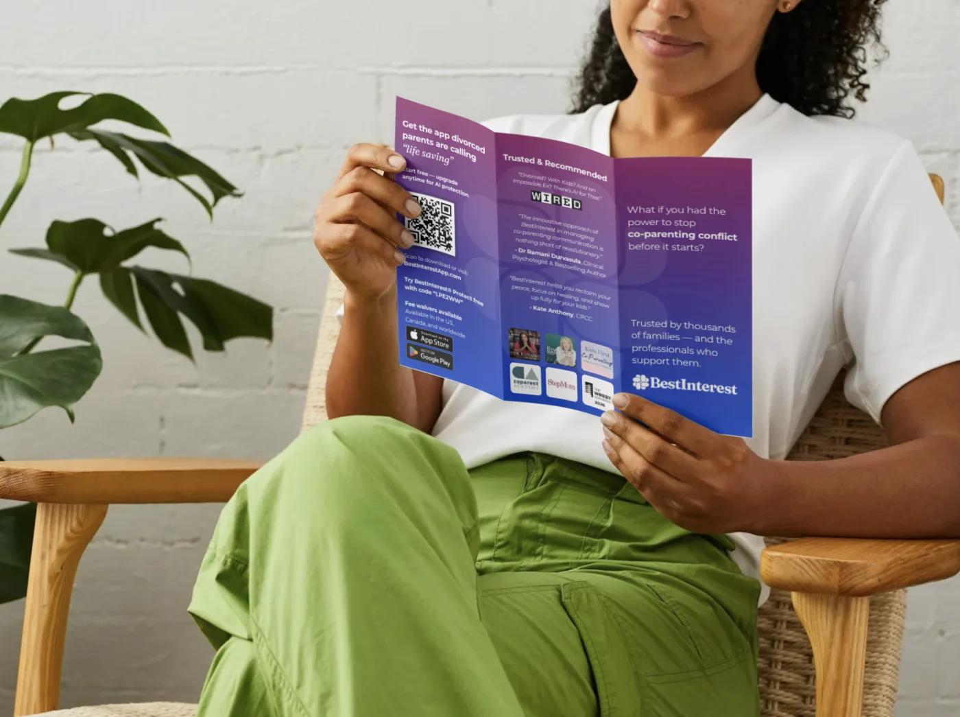 A professional reading a folded BestInterest brochure in an office